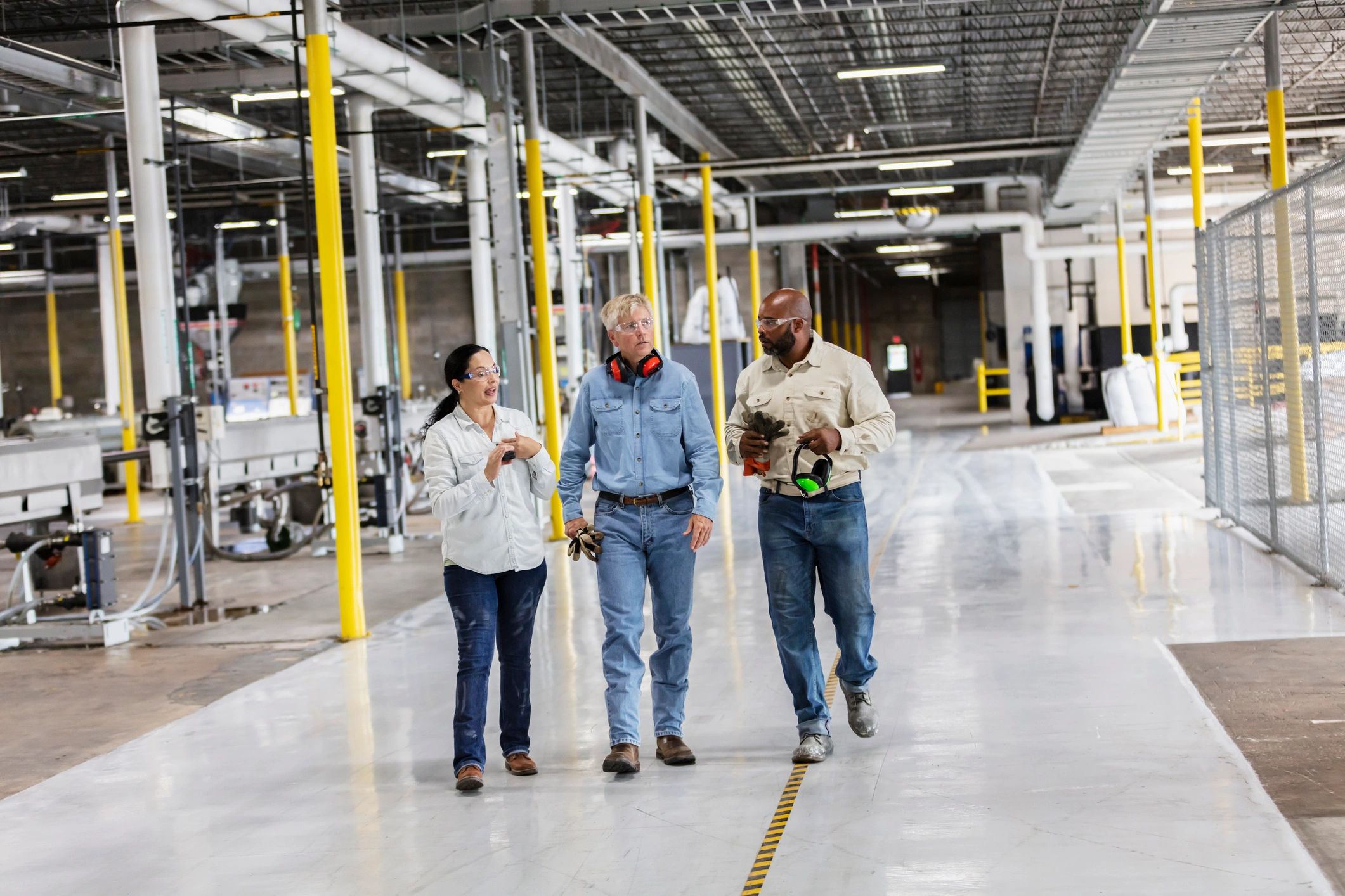 Operations team walking and discussing on a factory floor
